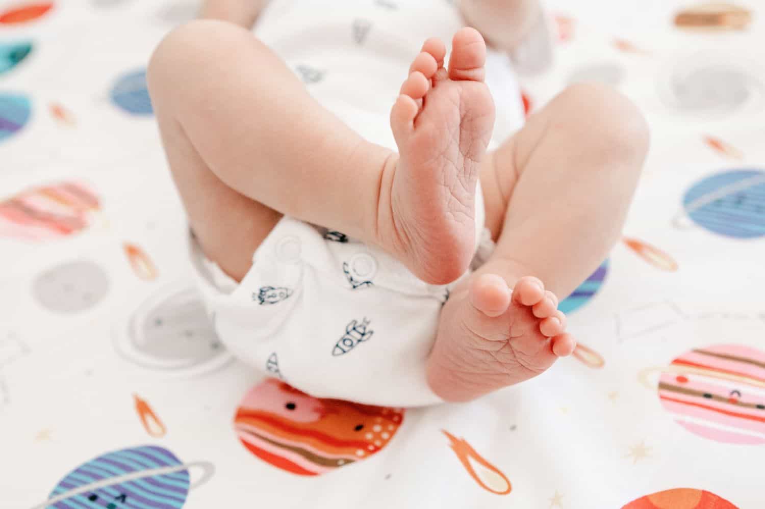 Close-up photo of a new baby boy's tiny feet.