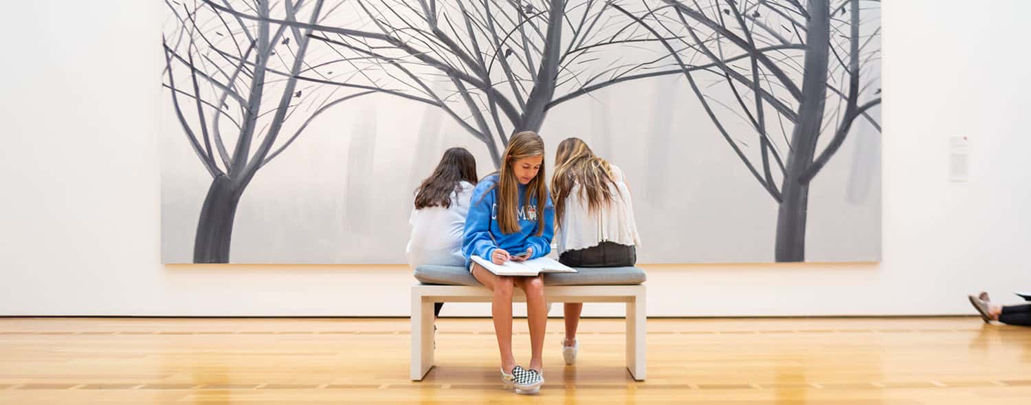 Build Your Dream Photography Business on a Budget: Kids sit in front of painting at museum