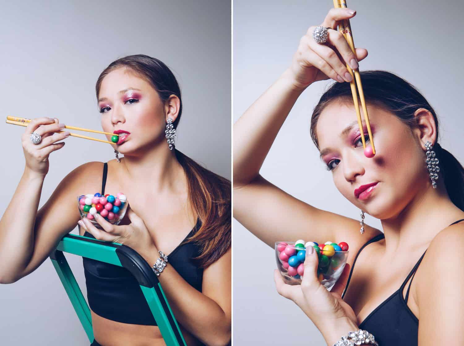 An Asian model in a black bustier top poses with gumballs and chopsticks