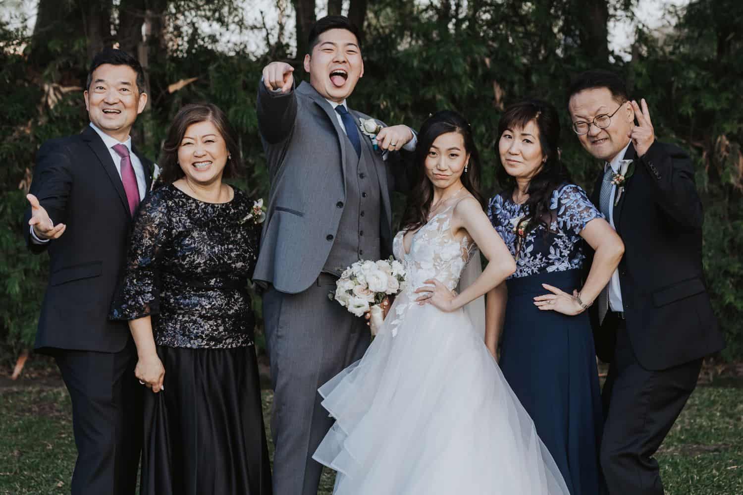 Family members act silly for their wedding day portrait