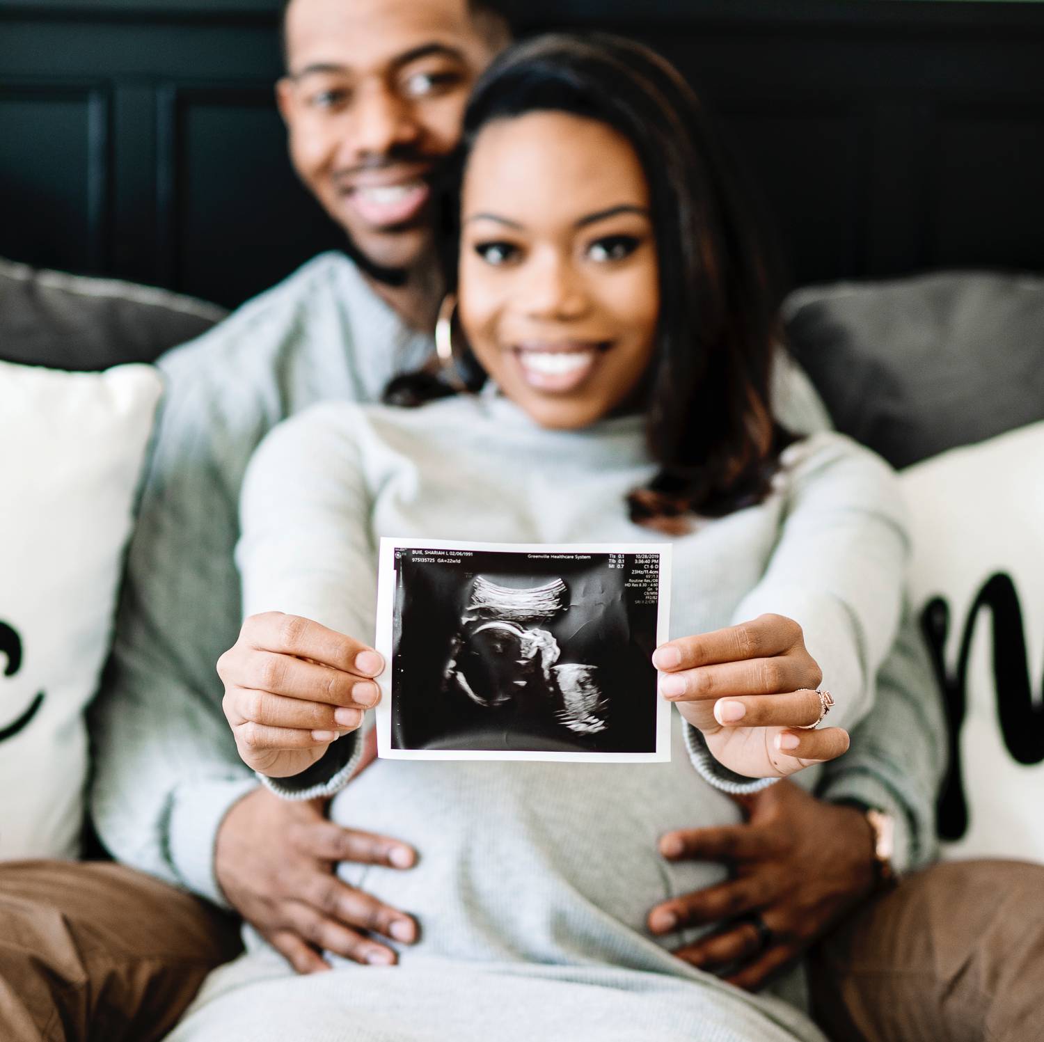 Sasha Q. Photography's maternity posing is simple and fun, like this shot with the parents showing off their sonogram photo.