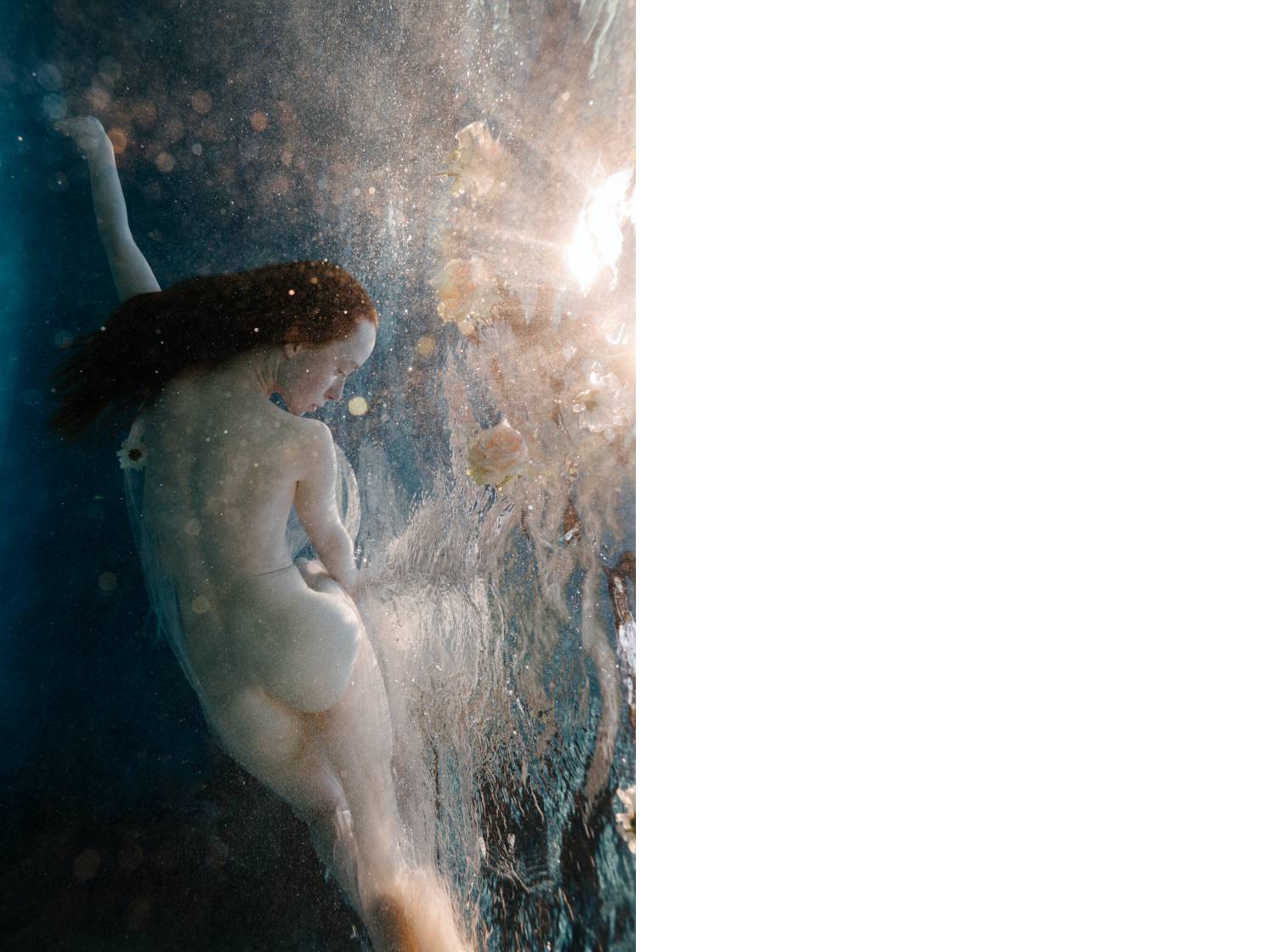 Birdee's underwater photograph of a nude woman with flowing red hair. The sun flare spilling into the water looks like the tentacles of a massive jellyfish.