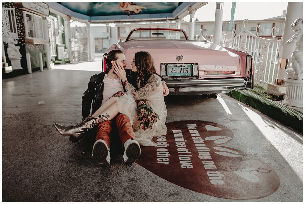 couple in front of pink car