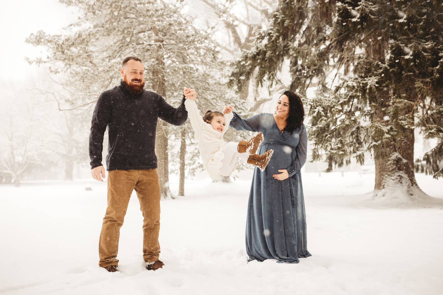 Couples maternity portrait in the snow