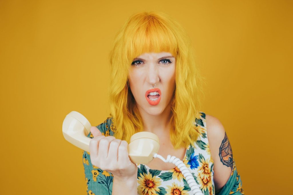 Girl with yellow hair holding a phone