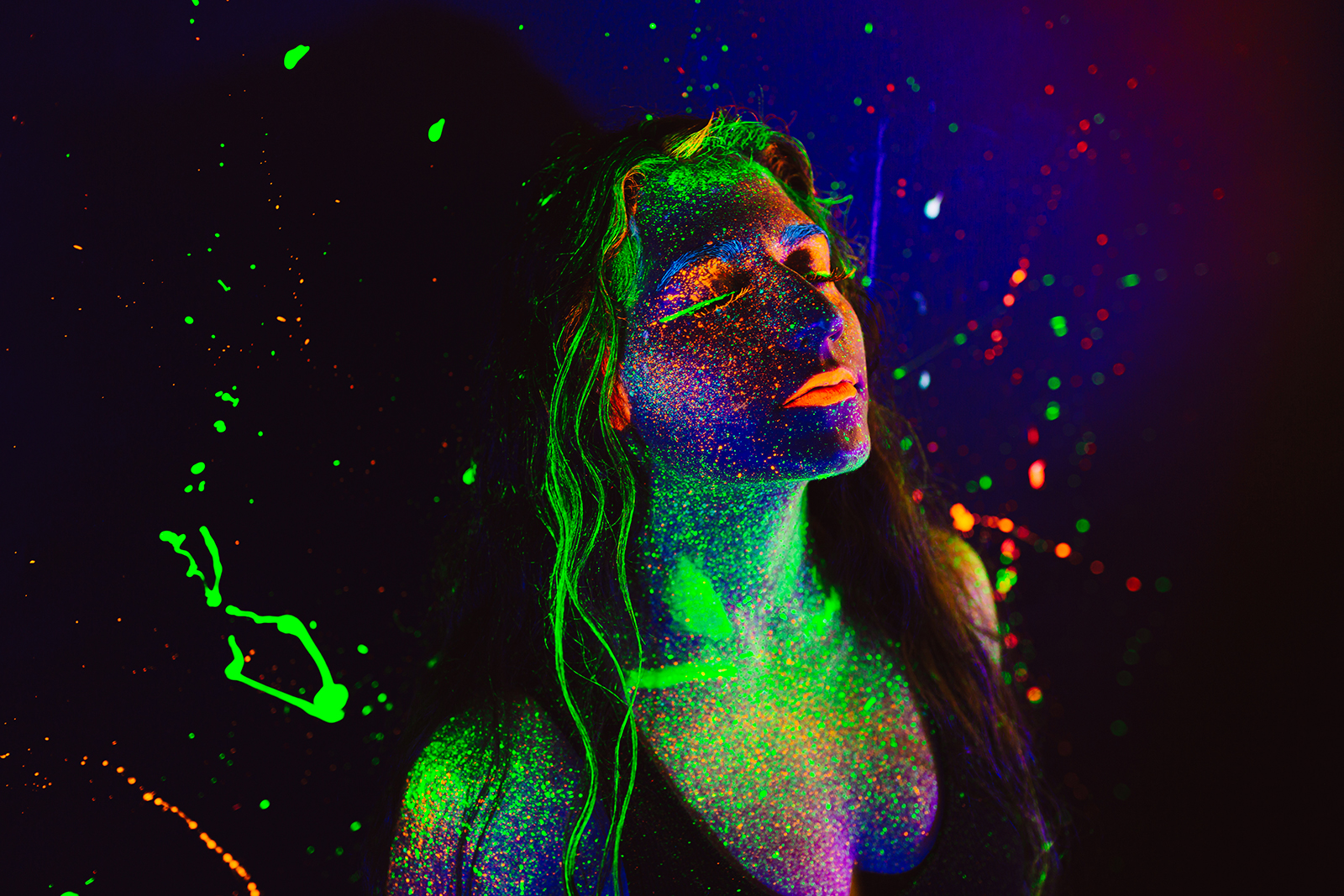 Portrait of girl with splattered UV paint