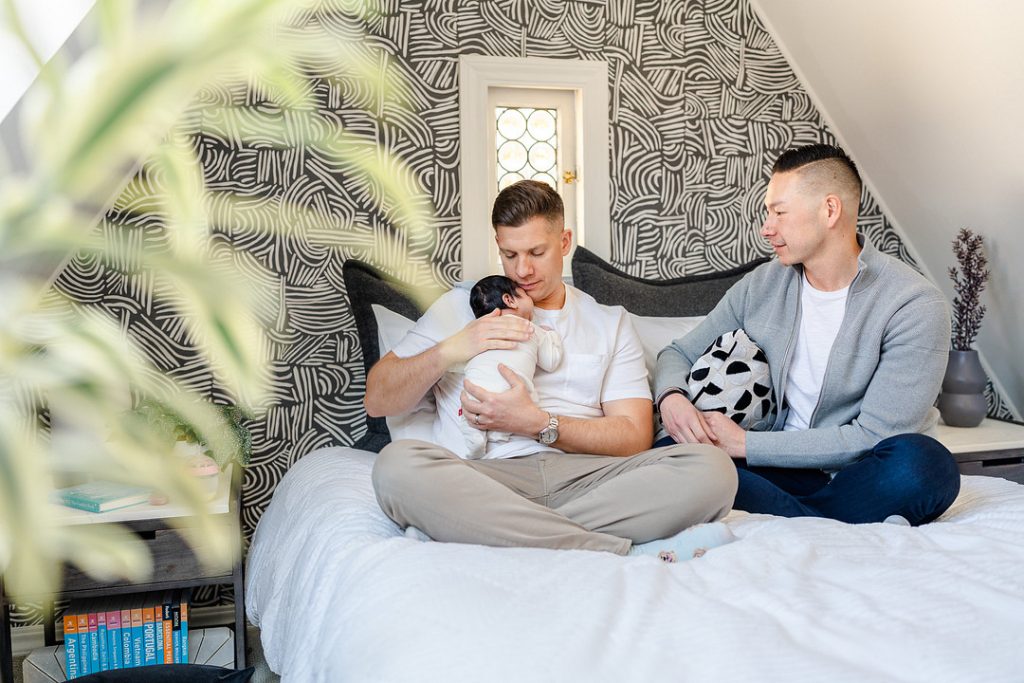 couple on bed with baby