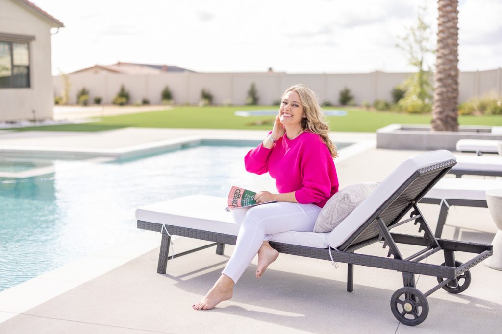 woman in pink sitting at pool