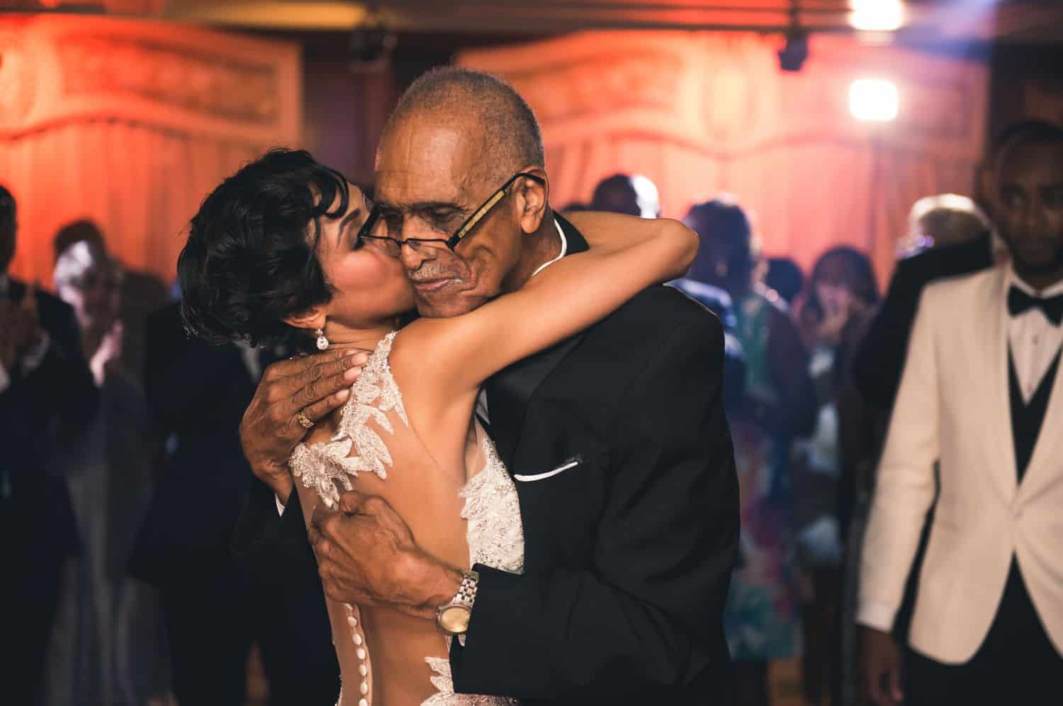 A bride and her father hugging each other