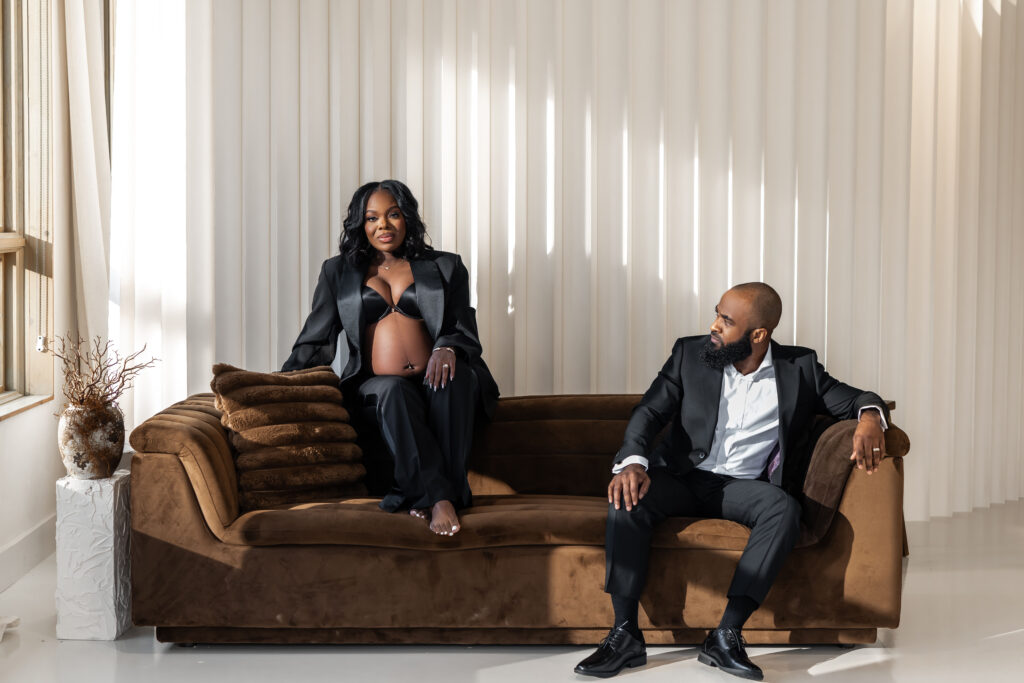 couple sitting on a brown couch