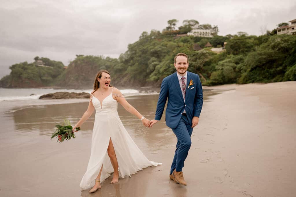 wedding couple laughing on the beach