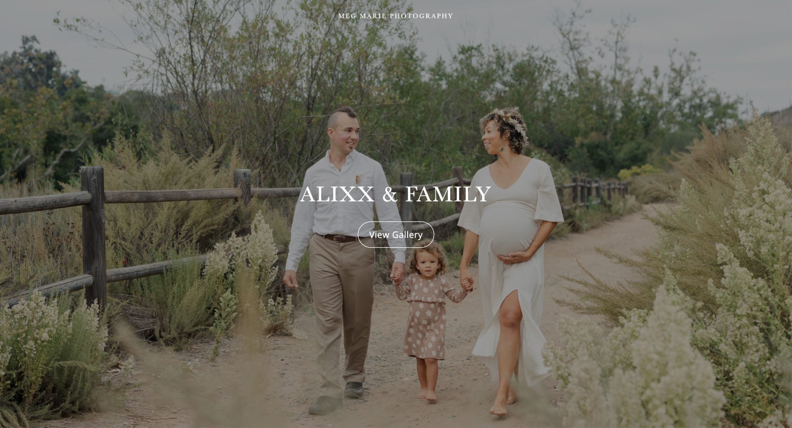 Family portrait: pregnant woman, man, and toddler girl holding hands, walking on a dirt path