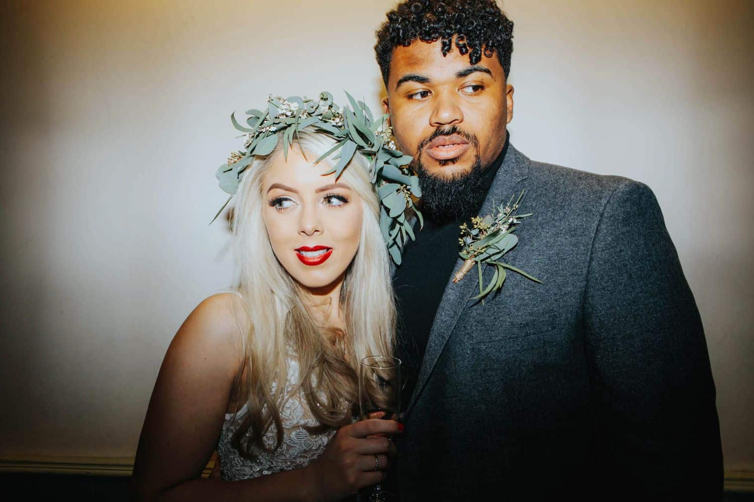 How To Make A Photography Website Your Dream Clients Can’t Resist: A bride and groom pose closely, looking in opposite directions.