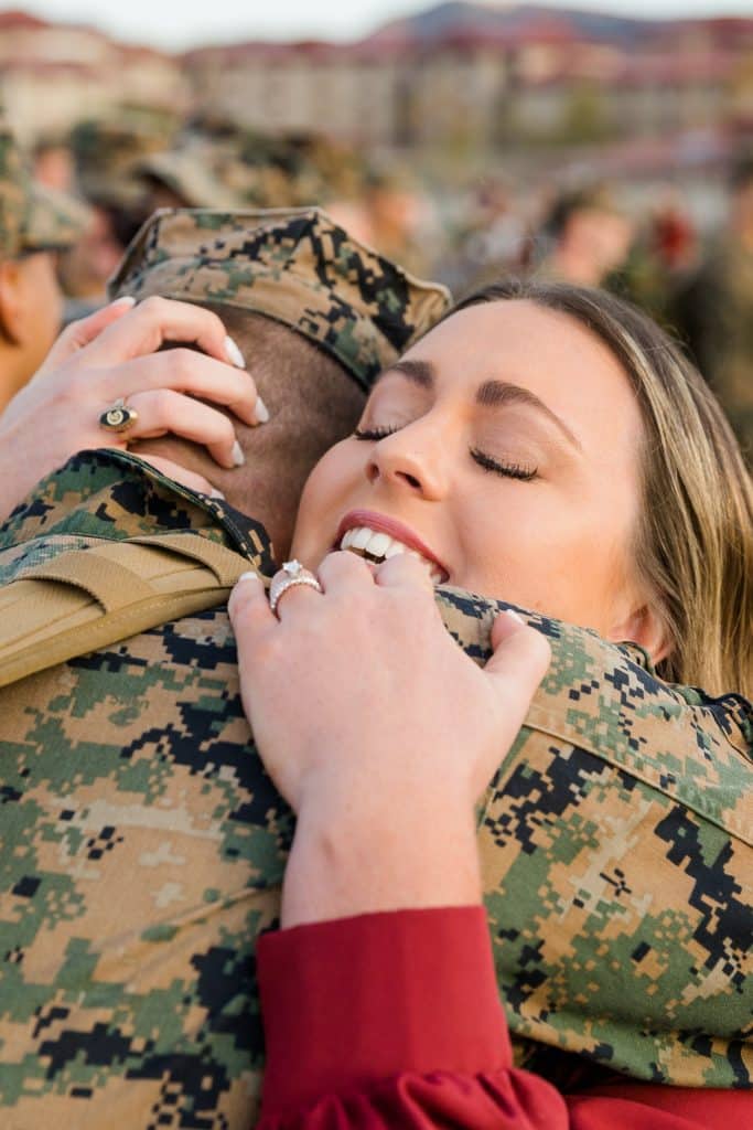 couple embracing at military homecoming