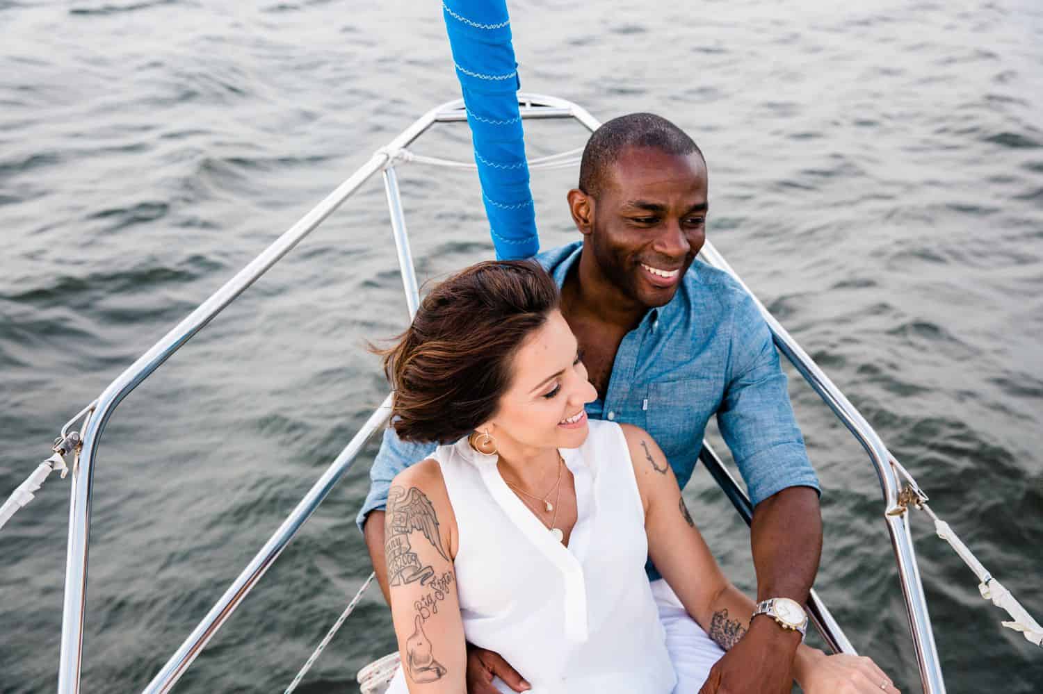 A Black man sails on a sailboat with his wife