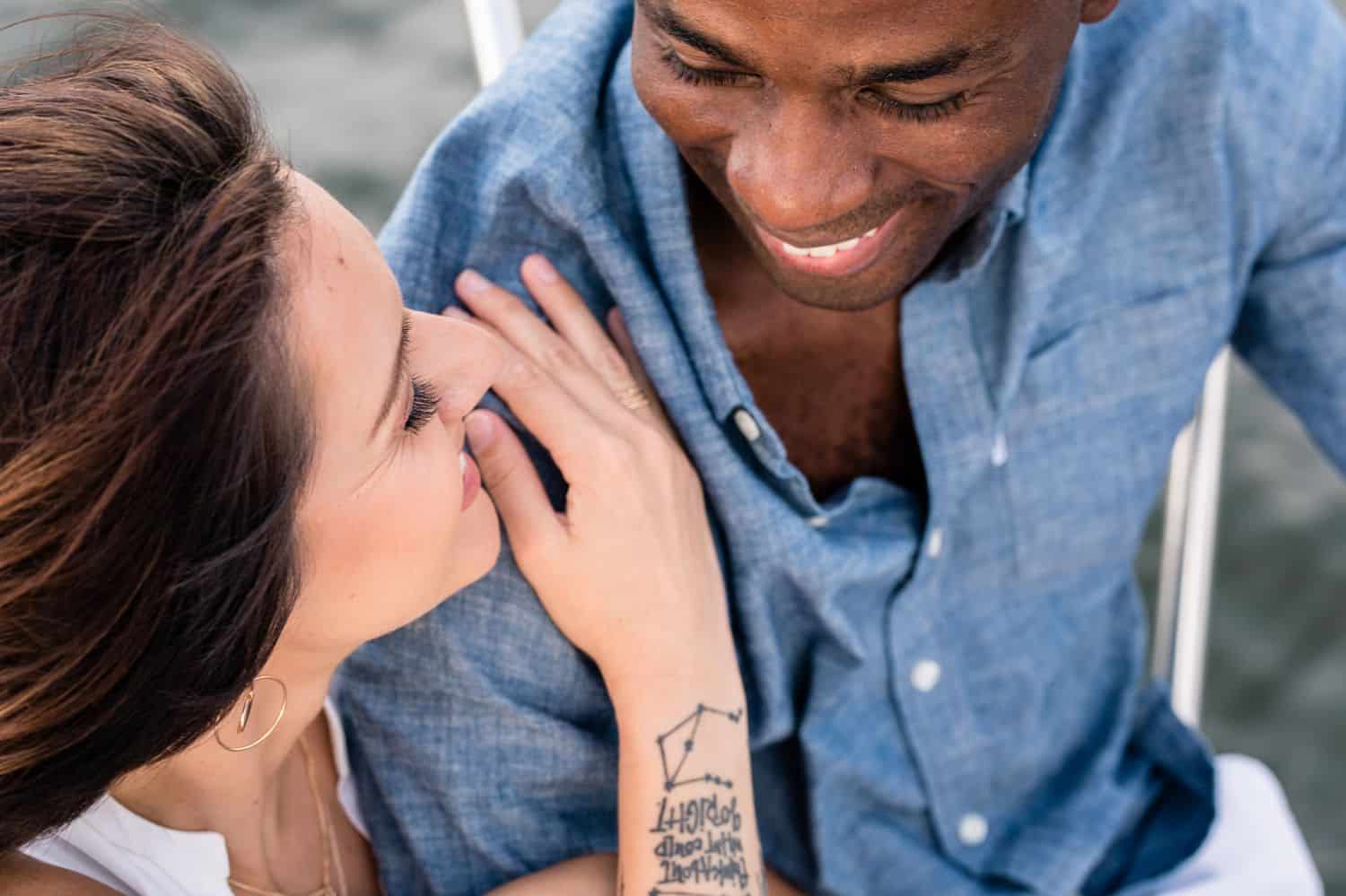 A man and woman are photographed from above as they smile at each other